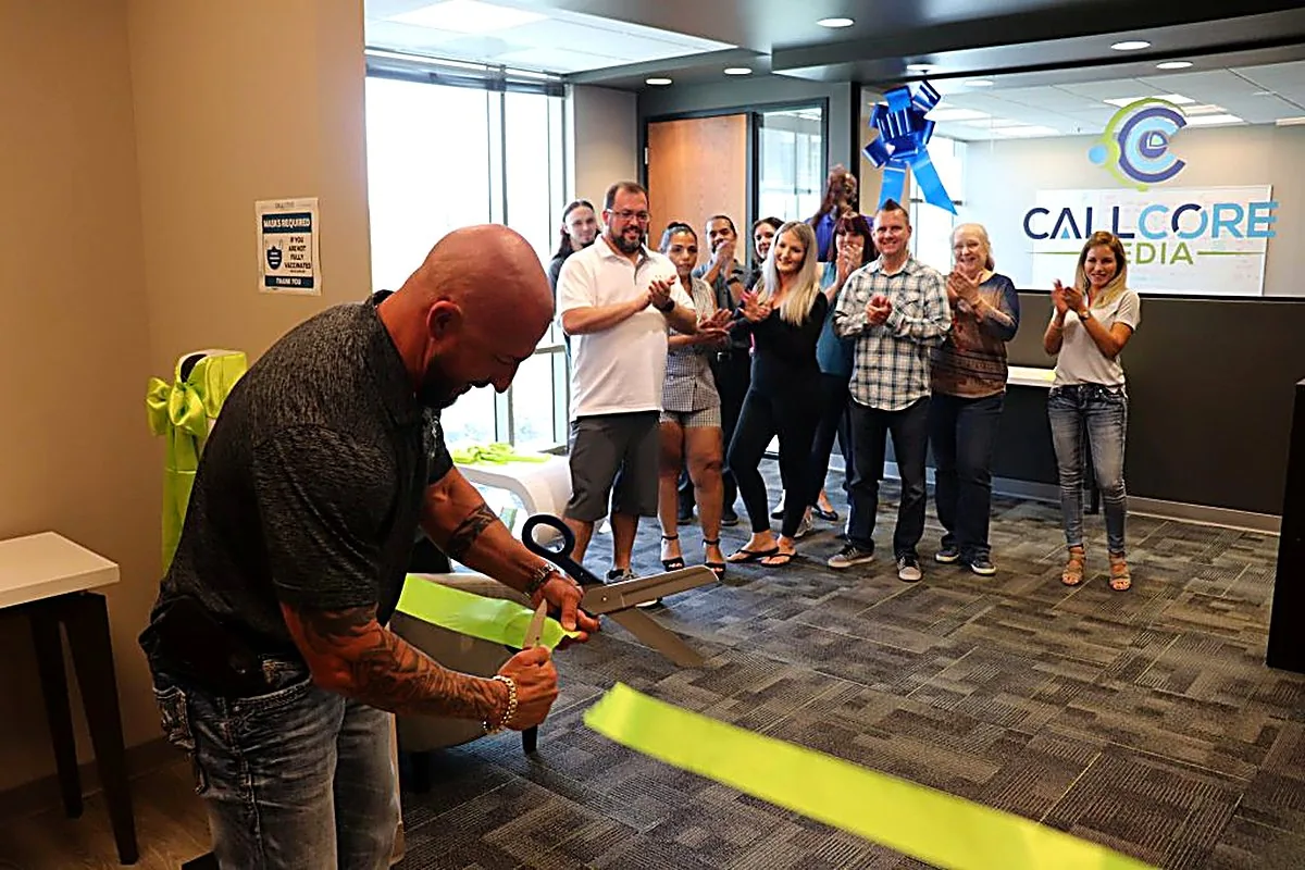 CallCore Media team — grand opening ribbon cutting